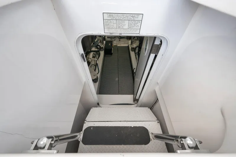 Magadi Yacht Photos Pics Engine room entrance of 2015 Ritchie Howell Express boat, featuring clean white interior.