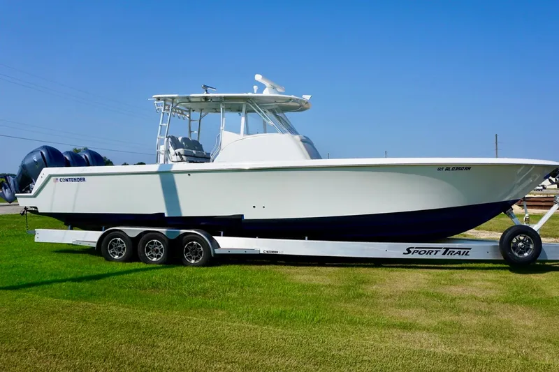  Yacht Photos Pics 2022 Contender 39 Fisharound boat on trailer, parked on grass under clear blue sky.