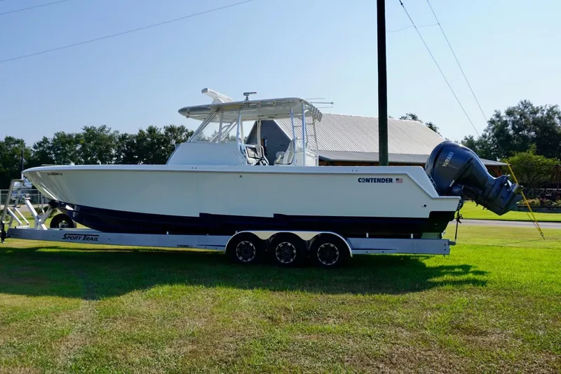  Yacht Photos Pics 2022 Contender 39 Fisharound boat on trailer, parked on grass, side view.