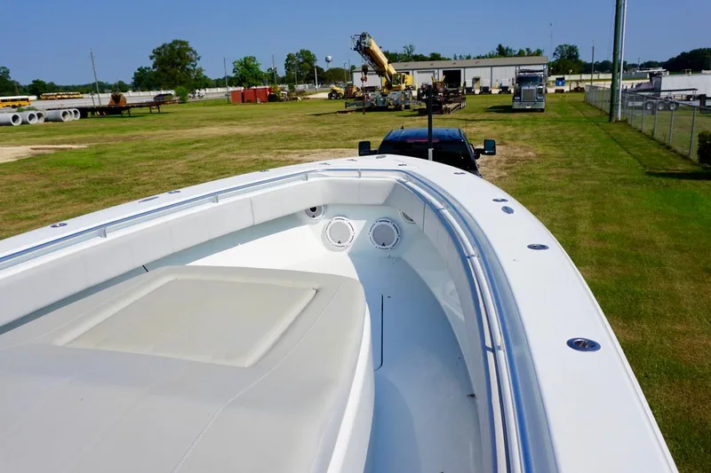  Yacht Photos Pics 2022 Contender 39 Fisharound boat on trailer in industrial yard setting.