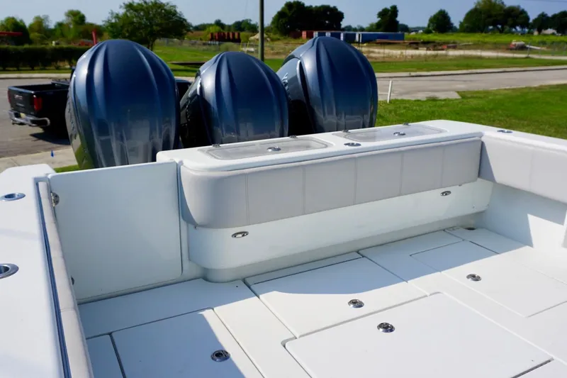  Yacht Photos Pics 2022 Contender 39 Fisharound boat with triple outboard engines, spacious deck, and seating area.