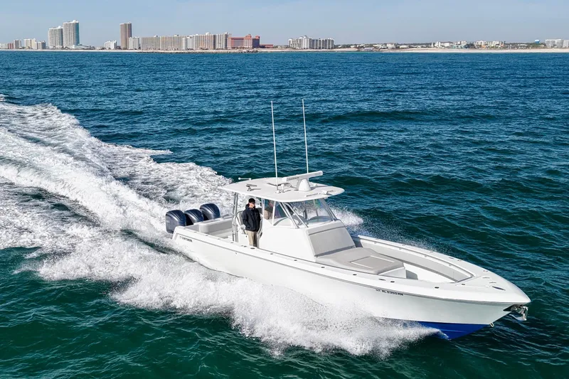  Yacht Photos Pics 2022 Contender 39 Fisharound boat cruising on ocean near city skyline.