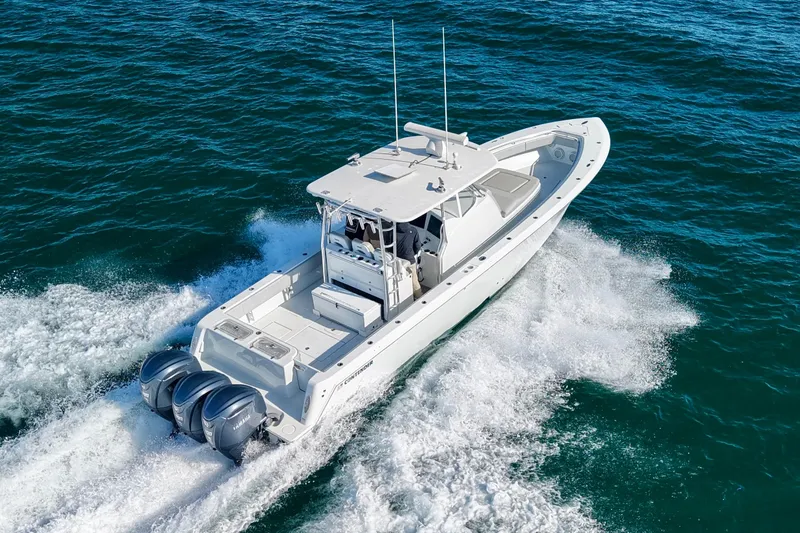  Yacht Photos Pics 2022 Contender 39 Fisharound boat cruising on open water, featuring triple outboard engines.