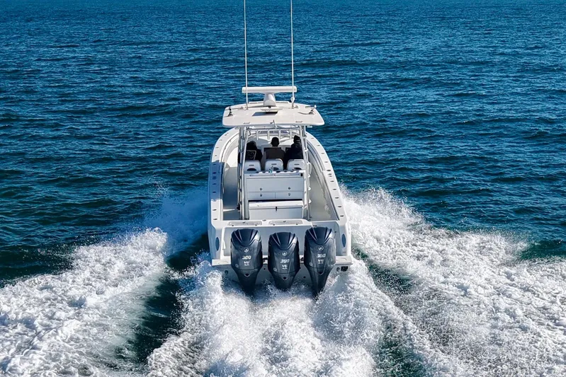  Yacht Photos Pics 2022 Contender 39 Fisharound boat cruising on open water with triple outboard engines.