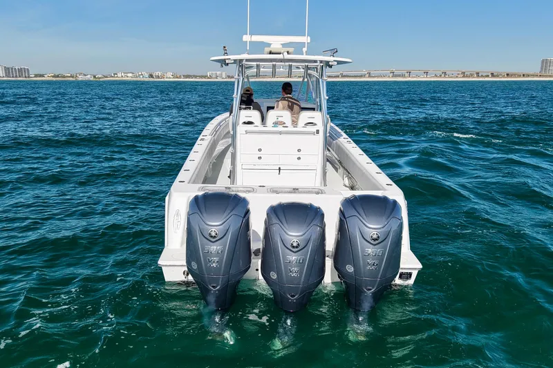  Yacht Photos Pics 2022 Contender 39 Fisharound boat with triple Yamaha engines on open water.