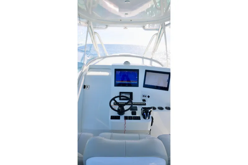  Yacht Photos Pics 2022 Contender 39 Fisharound boat cockpit with modern navigation displays.