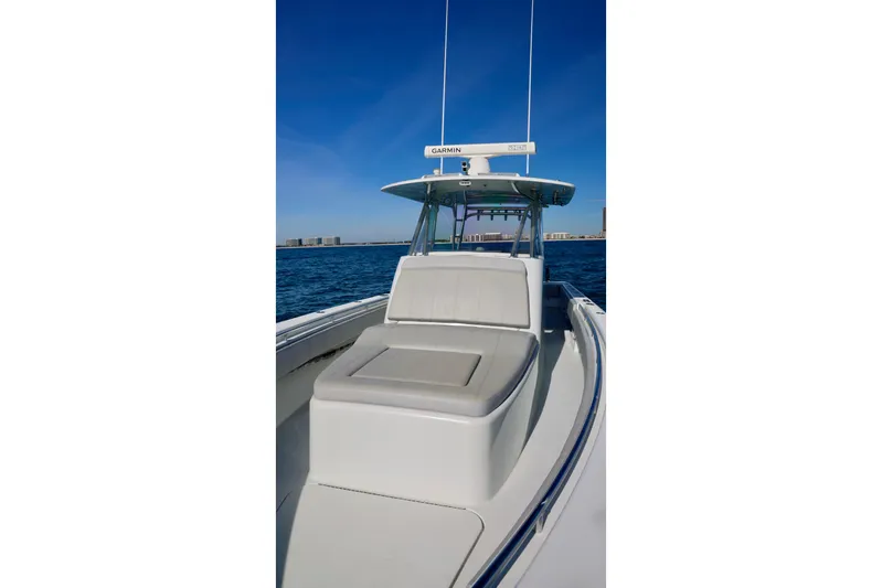  Yacht Photos Pics 2022 Contender 39 Fisharound boat on open water, featuring sleek design and comfortable seating.