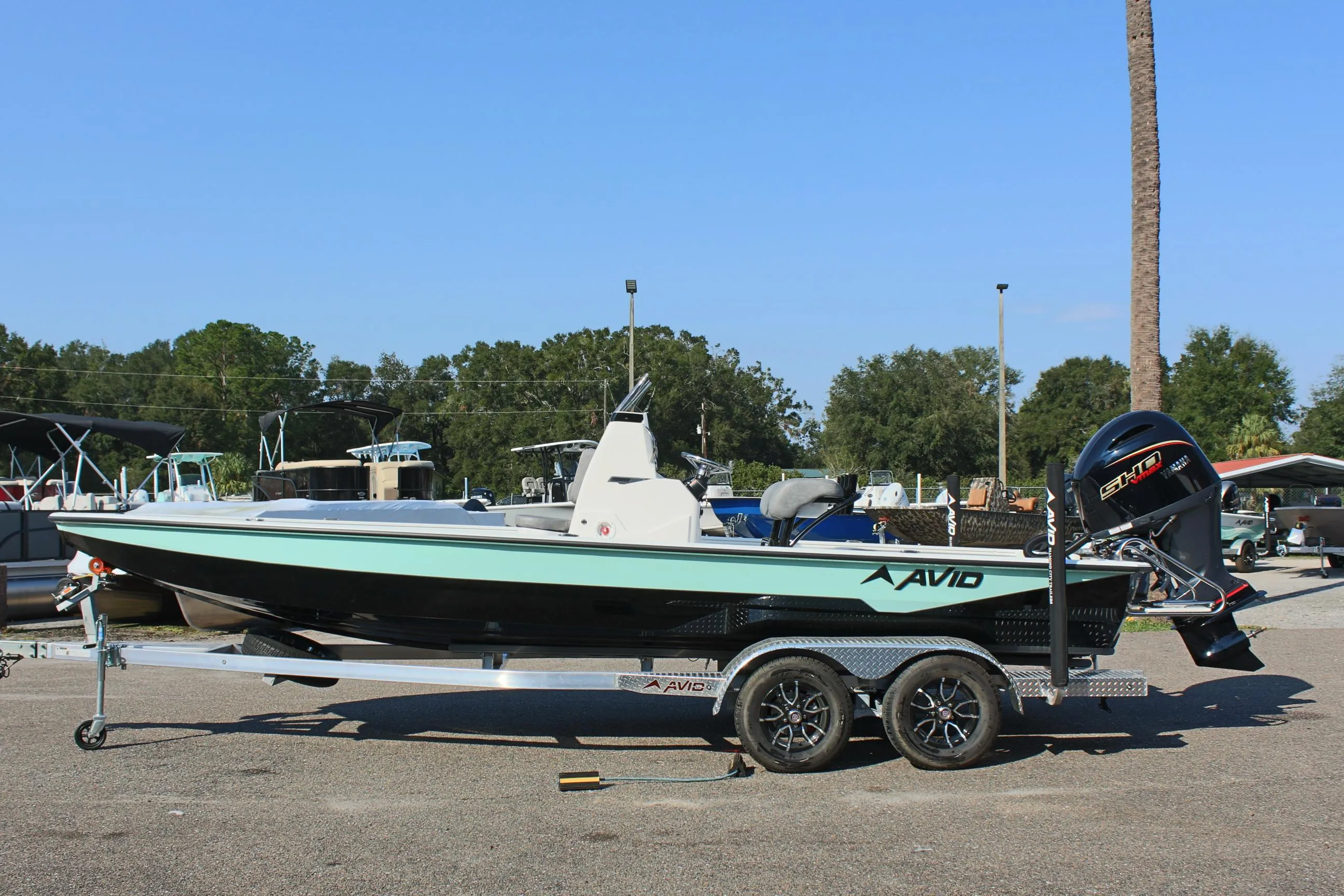 2025 Avid 23 FSX boat on trailer in outdoor setting.