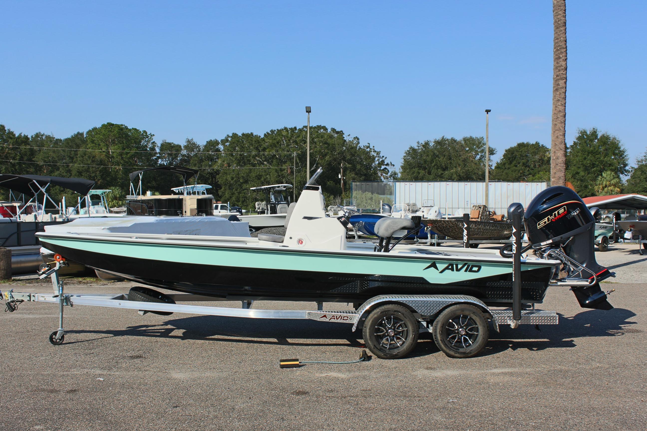 2025 Avid 23 FSX boat on trailer, parked outdoors.