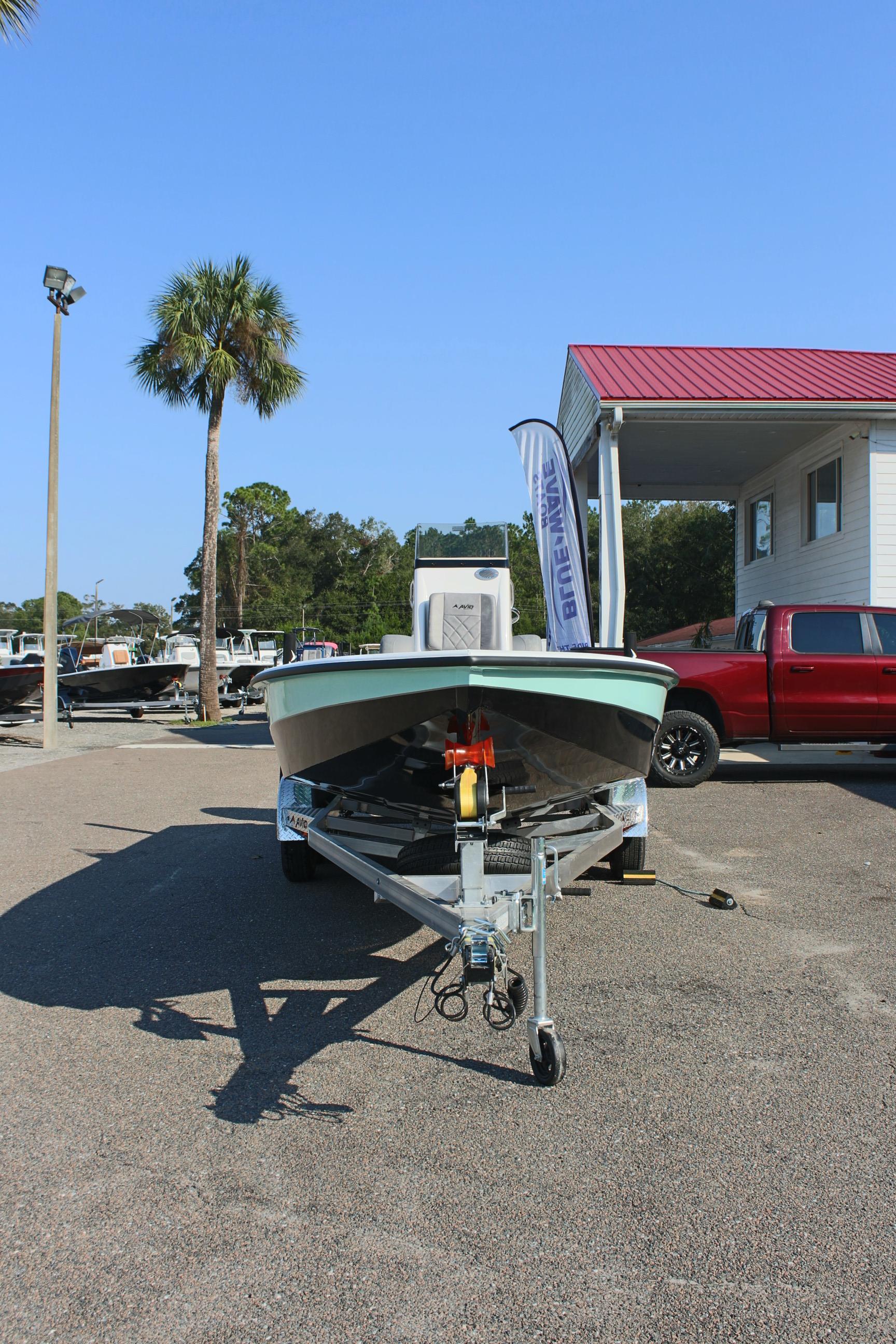 2025 Avid 23 FSX boat on trailer in sunny outdoor setting.