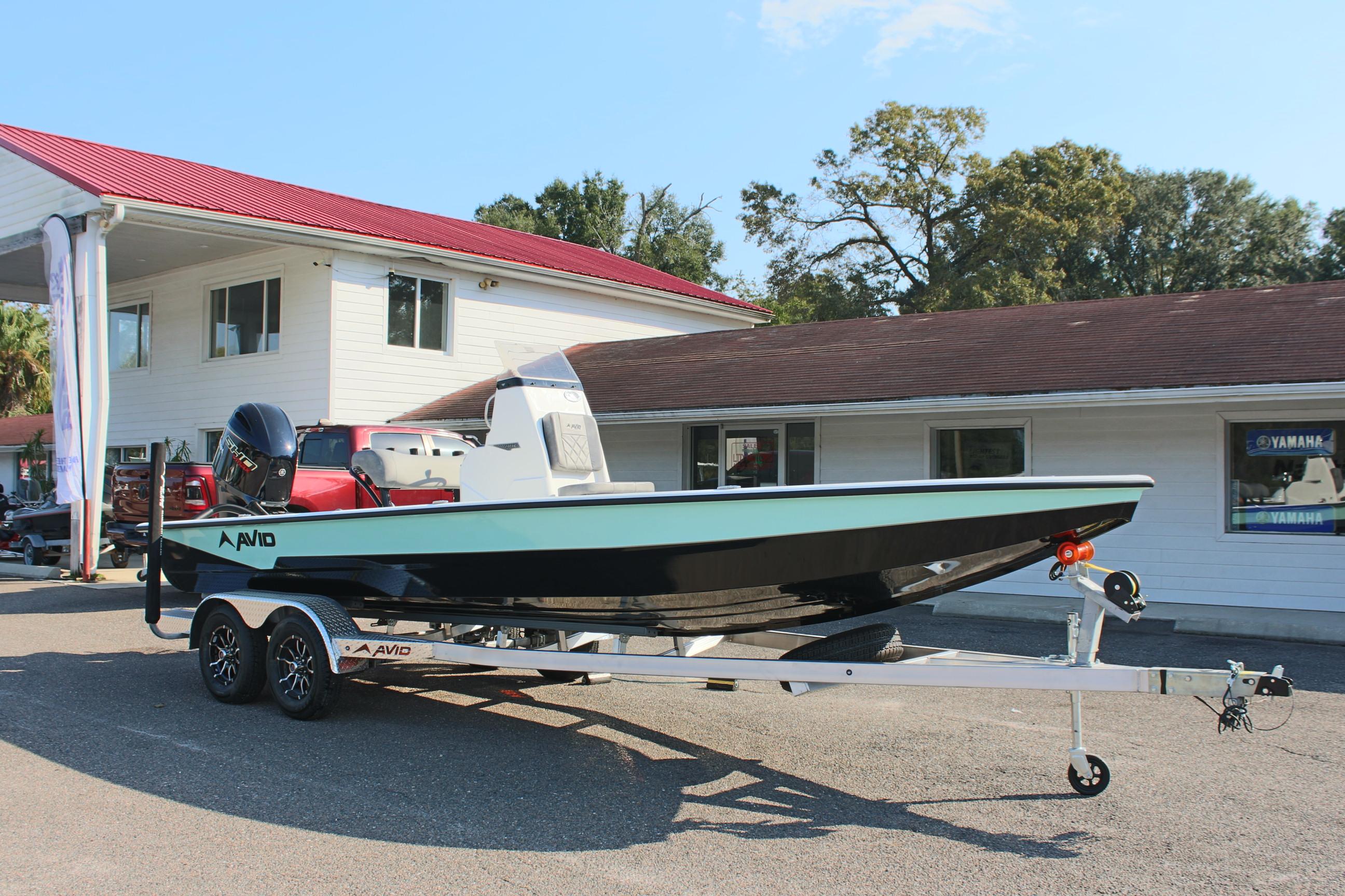 2025 Avid 23 FSX boat on trailer outside dealership.