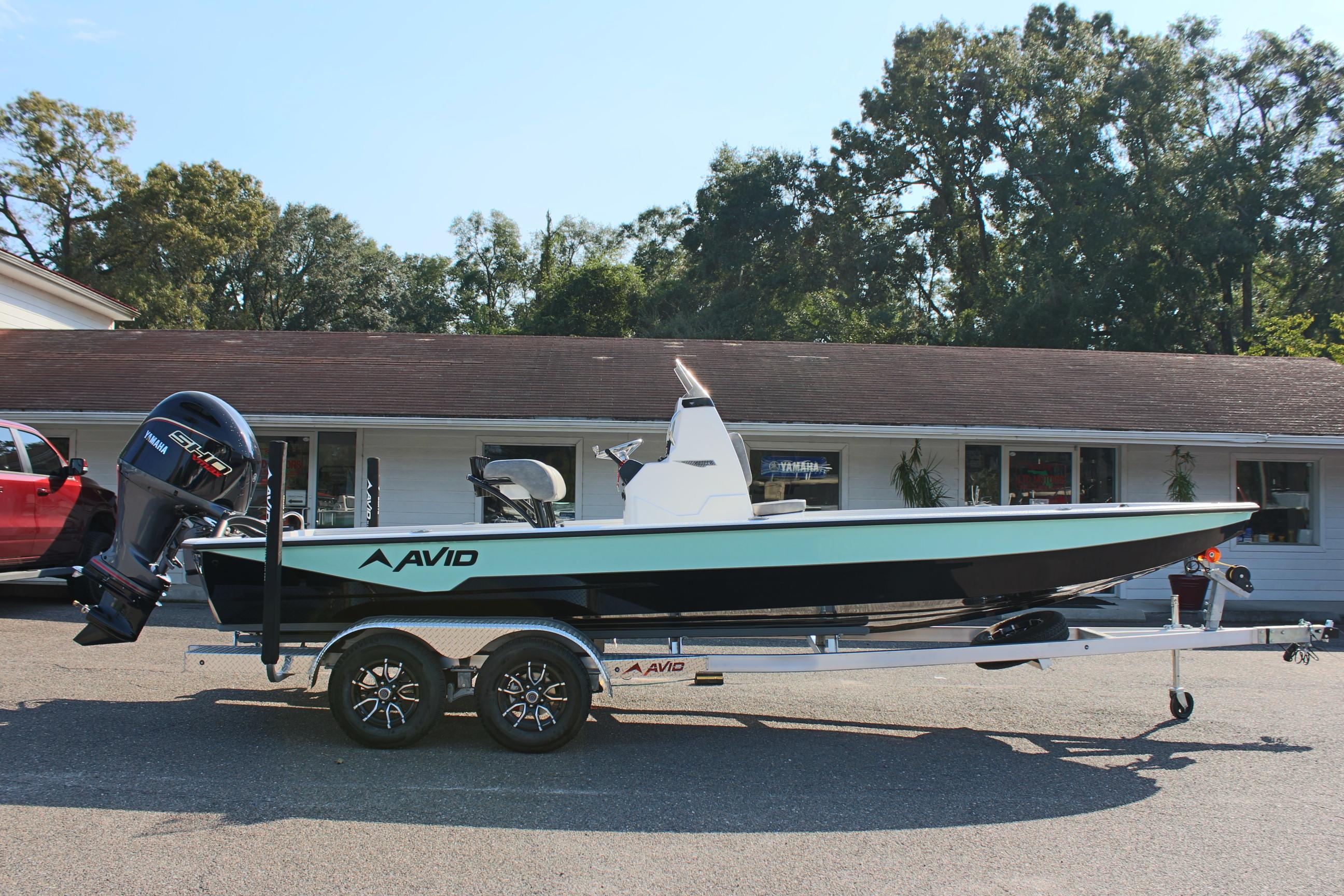 2025 Avid 23 FSX boat on trailer, parked outdoors.