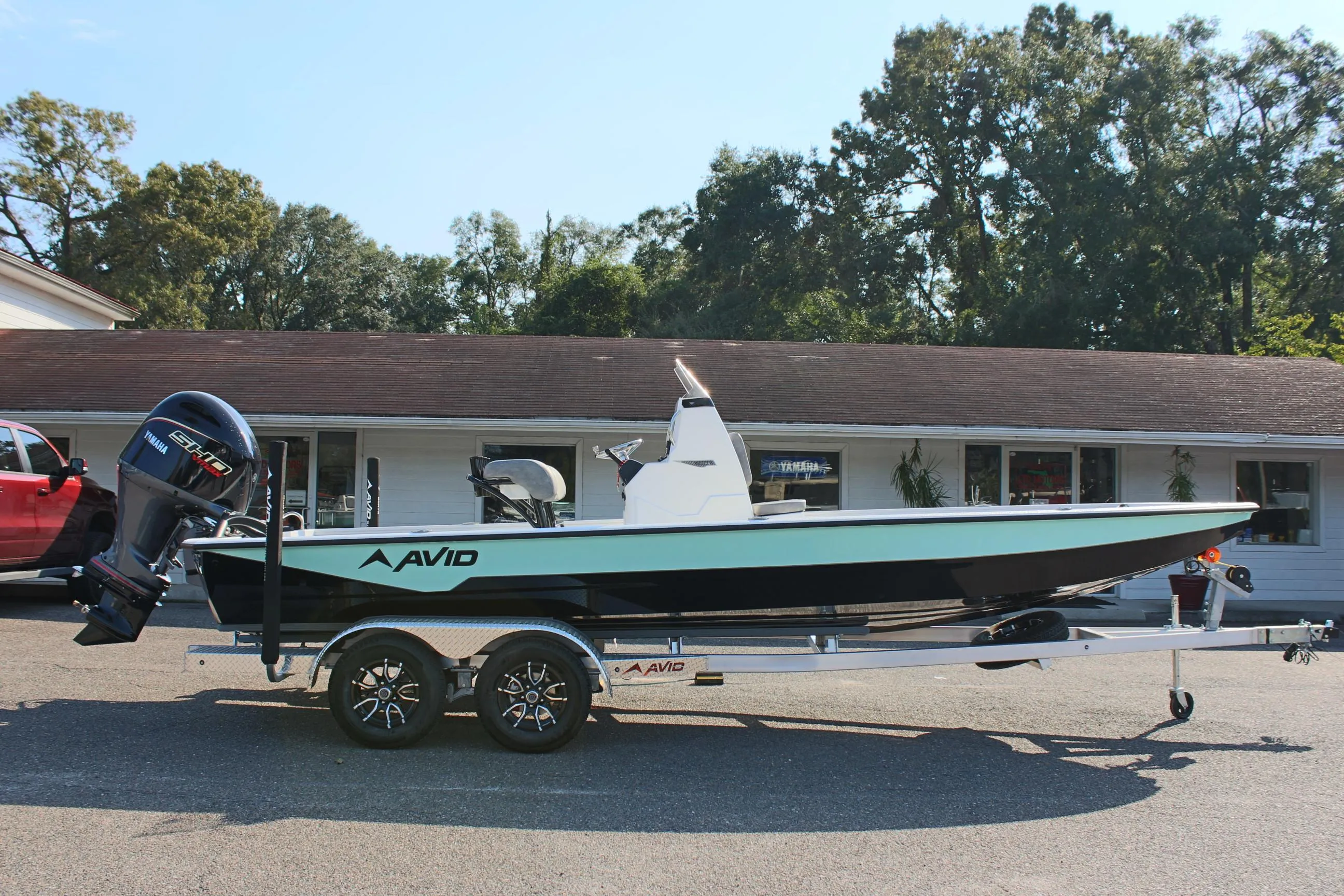 2025 Avid 23 FSX boat on trailer, parked outdoors.