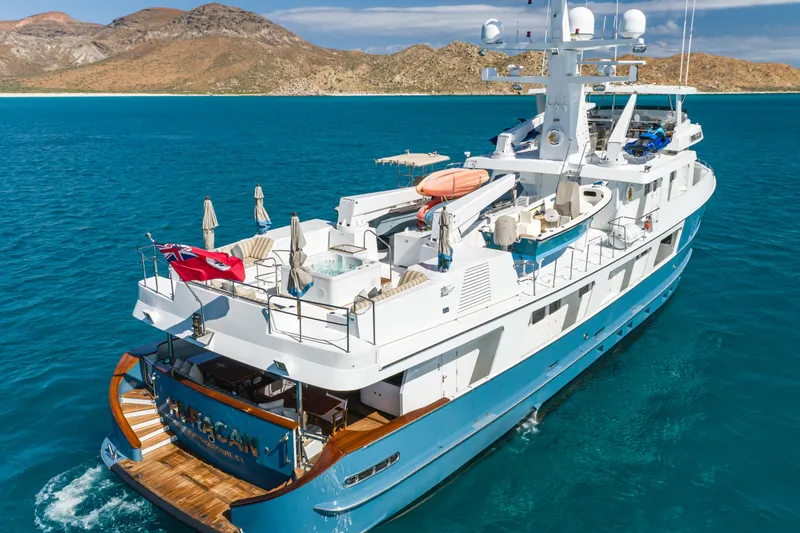 Huracan Yacht Photos Pics Luxurious 1991 Delta Marine Expedition yacht cruising in clear blue waters.