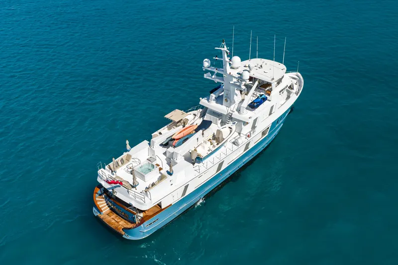 Huracan Yacht Photos Pics Aerial view of 1991 Delta Marine Expedition yacht on clear blue water.