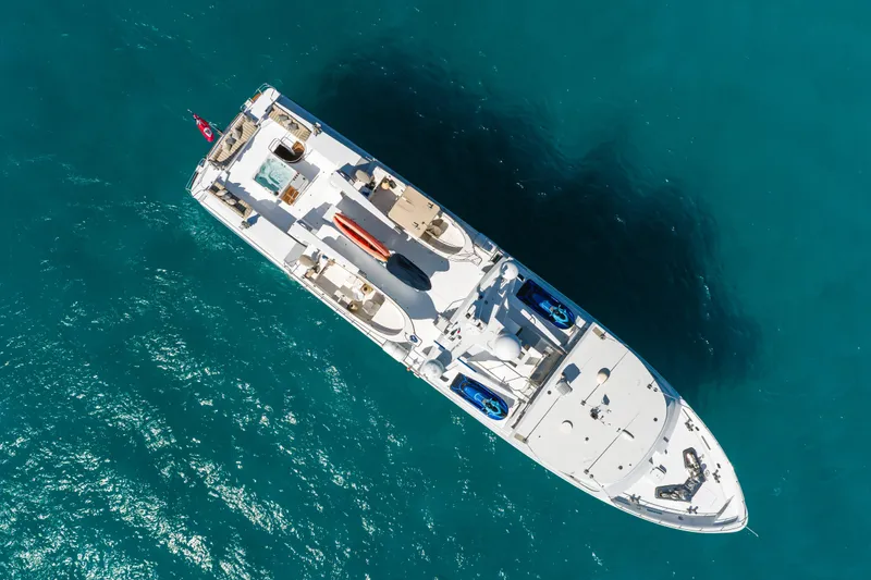 Huracan Yacht Photos Pics Aerial view of 1991 Delta Marine Expedition yacht on clear blue water.