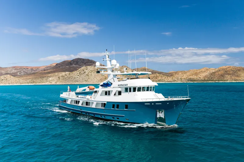 Huracan Yacht Photos Pics Delta Marine Expedition yacht cruising in clear blue waters, 1991 model.