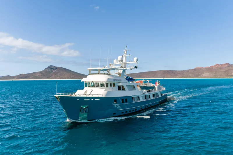 Huracan Yacht Photos Pics Delta Marine Expedition yacht cruising in clear blue waters, 1991 model.