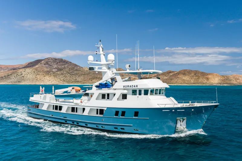 Huracan Yacht Photos Pics Delta Marine Expedition yacht cruising in clear blue waters, 1991 model.