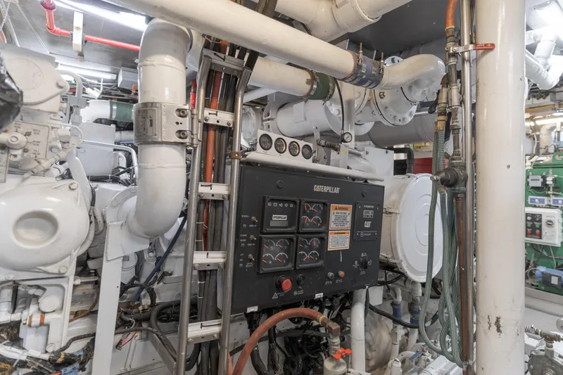 Huracan Yacht Photos Pics Engine room of 1991 Delta Marine Expedition yacht with complex machinery and control panel.