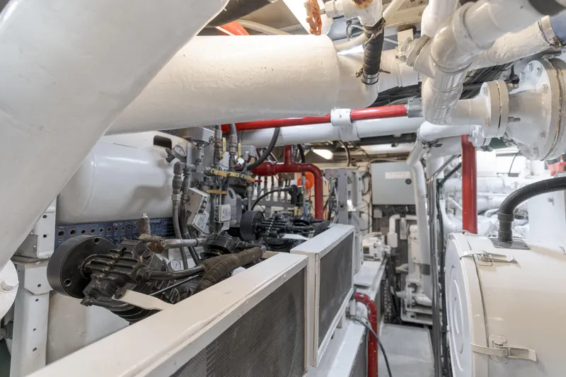 Huracan Yacht Photos Pics Engine room of 1991 Delta Marine Expedition yacht, showcasing complex machinery and piping.