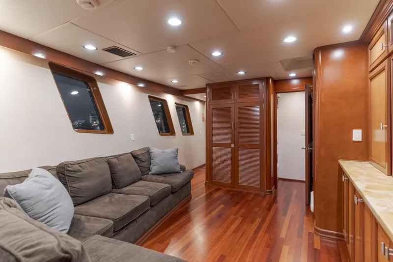 Huracan Yacht Photos Pics Luxurious interior of 1991 Delta Marine Expedition yacht with plush seating and wooden finishes.