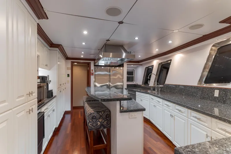 Huracan Yacht Photos Pics Luxurious kitchen interior of 1991 Delta Marine Expedition yacht with modern appliances and sleek design.