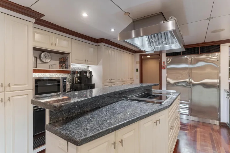 Huracan Yacht Photos Pics Luxurious kitchen on 1991 Delta Marine Expedition yacht with granite countertops and stainless steel appliances.