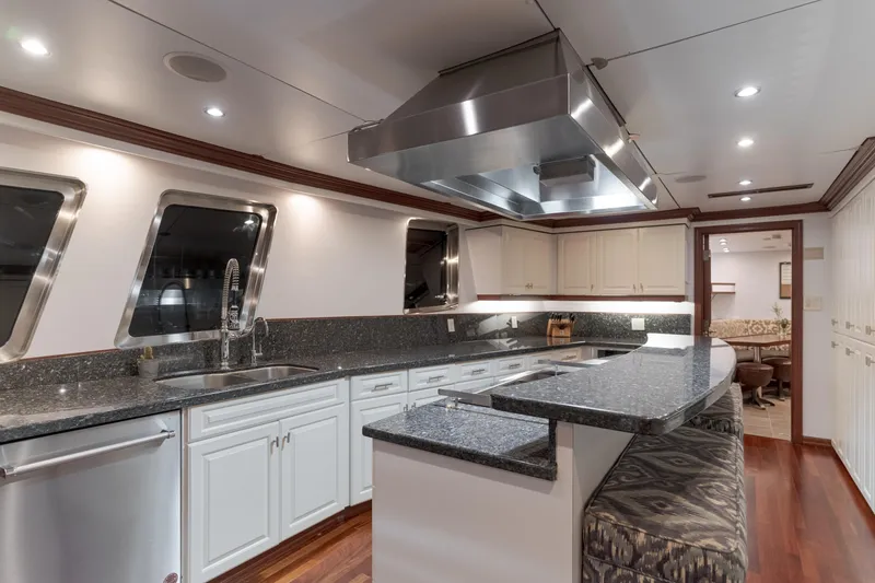 Huracan Yacht Photos Pics Luxurious kitchen interior on 1991 Delta Marine Expedition yacht with modern appliances and sleek design.