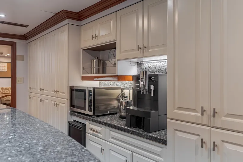 Huracan Yacht Photos Pics Luxurious yacht kitchen with white cabinets, granite countertops, and modern appliances. Delta Marine Expedition 1991.