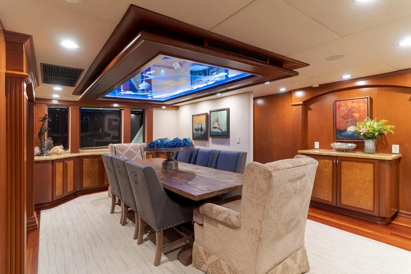 Huracan Yacht Photos Pics Luxurious dining area on 1991 Delta Marine Expedition yacht with elegant decor and ambient lighting.