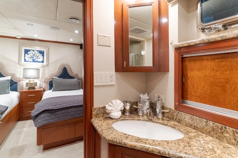 Huracan Yacht Photos Pics Luxurious 1991 Delta Marine Expedition yacht interior with elegant bedroom and bathroom.
