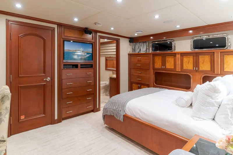 Huracan Yacht Photos Pics Luxurious 1991 Delta Marine Expedition yacht bedroom with elegant wood furnishings and modern amenities.