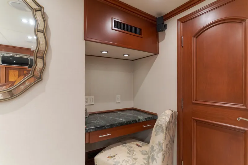 Huracan Yacht Photos Pics Elegant wooden vanity area with floral chair on Delta Marine Expedition yacht, 1991.