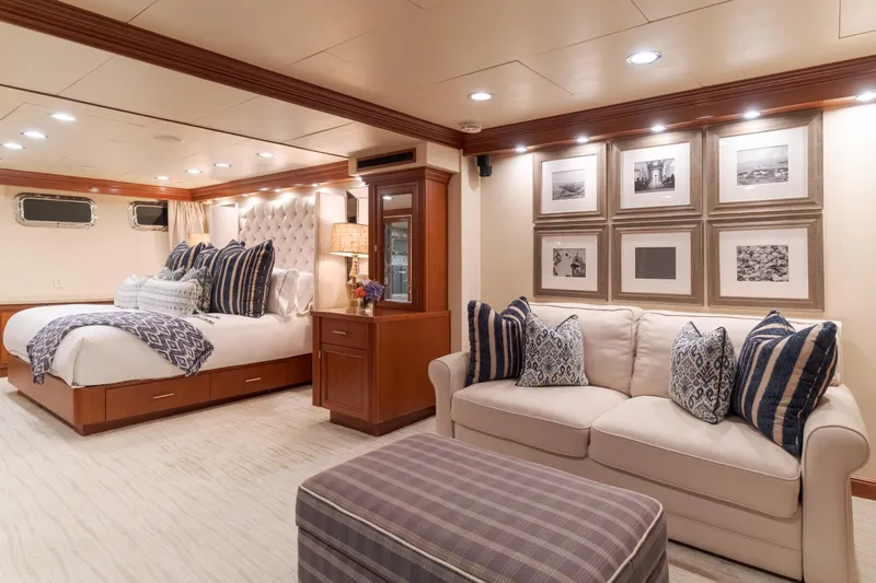 Huracan Yacht Photos Pics Luxurious 1991 Delta Marine Expedition yacht bedroom with elegant decor and cozy seating area.