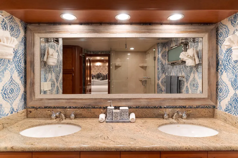 Huracan Yacht Photos Pics Luxurious bathroom with dual sinks and ornate blue wallpaper on Delta Marine Expedition yacht.