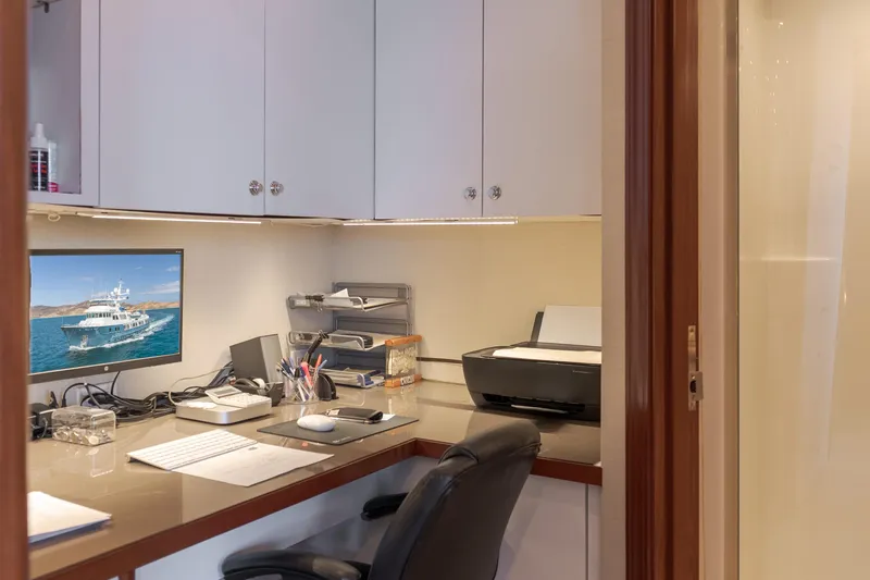 Huracan Yacht Photos Pics Office space on Delta Marine Expedition yacht, 1991 model, featuring desk, computer, and printer.