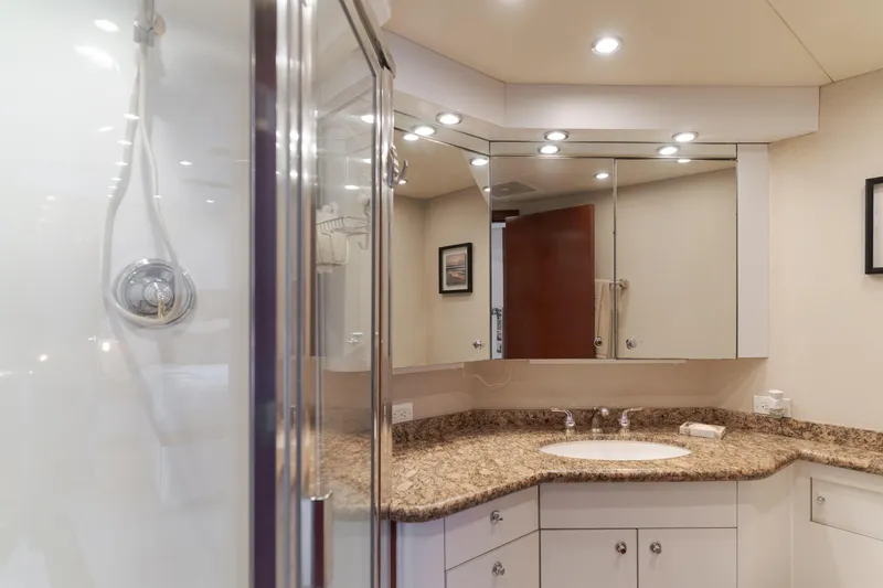 Huracan Yacht Photos Pics Luxurious bathroom in 1991 Delta Marine Expedition yacht with granite countertop and modern fixtures.