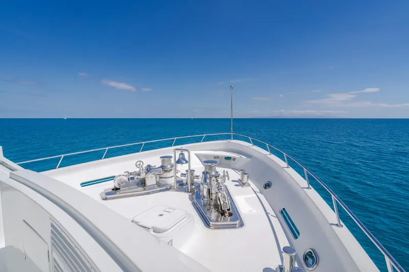 Huracan Yacht Photos Pics Delta Marine Expedition yacht deck, 1991 model, cruising on clear blue ocean.