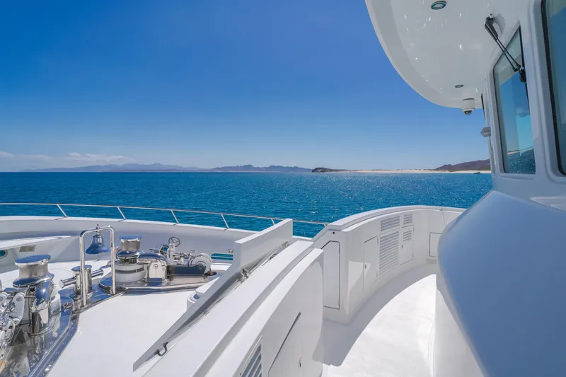 Huracan Yacht Photos Pics Delta Marine Expedition yacht deck overlooking blue ocean and distant coastline, 1991 model.