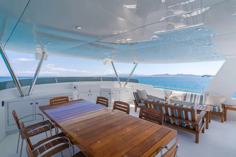 Huracan Yacht Photos Pics Luxurious 1991 Delta Marine Expedition yacht deck with ocean view, featuring elegant seating and dining area.