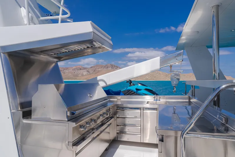 Huracan Yacht Photos Pics Outdoor kitchen on 1991 Delta Marine Expedition yacht with ocean view and jet ski.