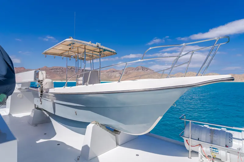 Huracan Yacht Photos Pics 1991 Delta Marine Expedition boat on deck, clear blue sky, and ocean backdrop.