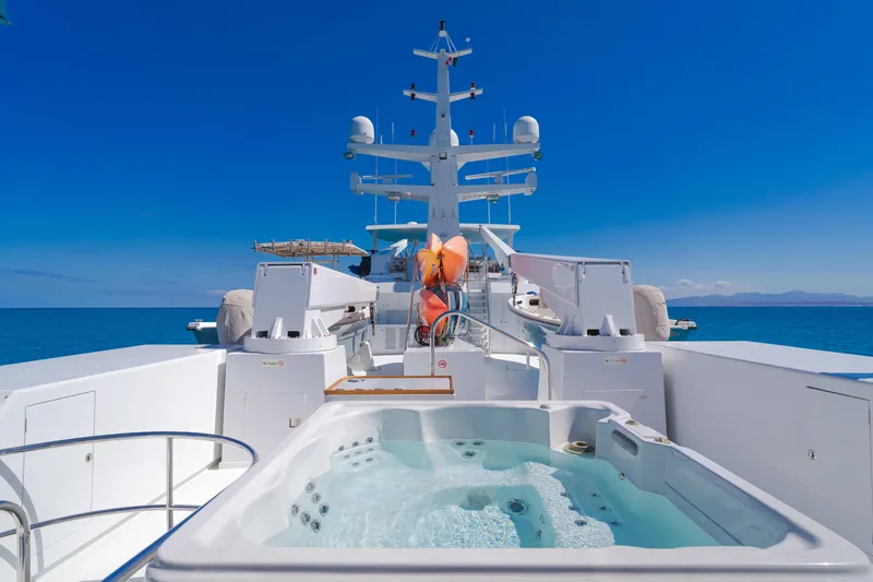 Huracan Yacht Photos Pics Luxurious 1991 Delta Marine Expedition yacht with jacuzzi, cruising on a clear blue sea.