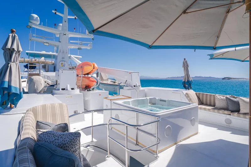 Huracan Yacht Photos Pics Luxurious 1991 Delta Marine Expedition yacht deck with hot tub and ocean view.