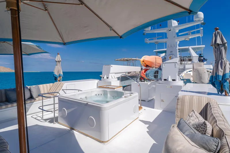 Huracan Yacht Photos Pics Luxurious 1991 Delta Marine Expedition yacht deck with jacuzzi and ocean view.