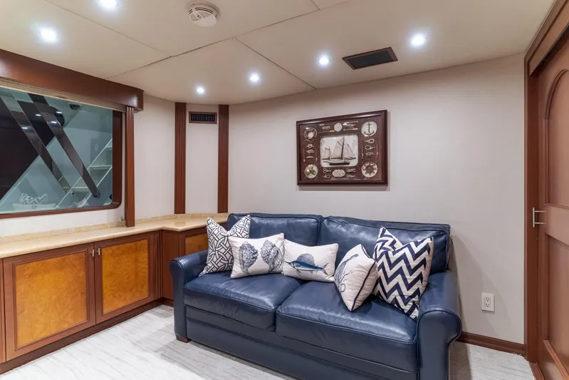 Huracan Yacht Photos Pics Luxurious 1991 Delta Marine Expedition yacht interior with blue sofa and nautical decor.