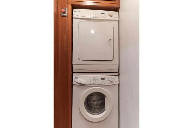 Huracan Yacht Photos Pics Stacked washer and dryer in a wooden cabinet on Delta Marine Expedition yacht, 1991.