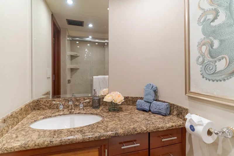 Huracan Yacht Photos Pics Luxurious bathroom on 1991 Delta Marine Expedition yacht with granite countertop and elegant decor.