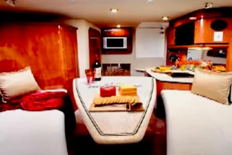  Yacht Photos Pics Luxurious interior of 2007 Fountain 33 Sportfish Cruiser with cozy seating and dining area.
